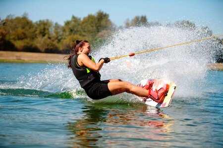 excited-young-woman-riding-wakeboard-royalty-free-image-1622050074.jpg