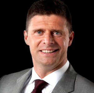 niall-quinn-headshot-black.jpg