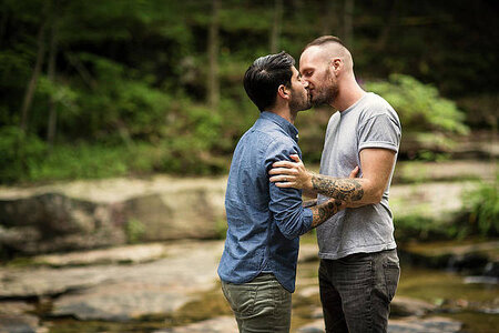 homosexual-couple-kissing-in-forest-cavan-images.jpg