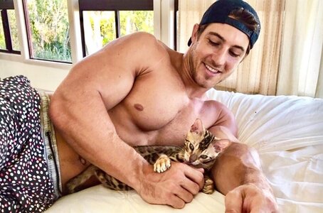 adorable-shirtless-hunk-pet-owner-smiling-bro-kitty-cat-playing-around-together.thumb.jpg.0c66...jpg