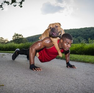 young-man-doing-pushups-on-rural-road-whilst-giving-royalty-free-image-1584471726.jpg