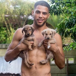 25-shirtless-man-holding-two-puppies.jpg