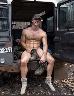 he poses with his stinky boots in his crotch with cheesy socks.jpeg