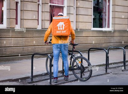 york-uk-april-17-2023-just-eat-delivery-driver-on-a-bicycle-york-uk-food-delivery-gig-economy-...jpg
