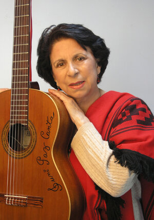 Suni_Paz_in_a_red_poncho,_holding_her_guitar.jpg