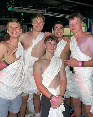 Ethan Wacker in a toga in between by a bunch of guys_1892x2364.jpg