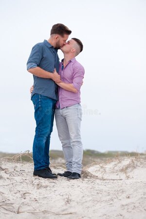 gay-men-embracing-beach-lovingly-cuddling-70931916.jpg