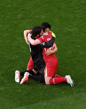 players Allison, Robertson and Endo at the final whistle.jpg