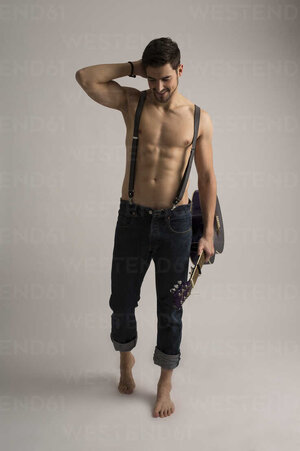 shirtless-man-with-guitar-wearing-jeans-and-suspenders-SHKF000128.jpg
