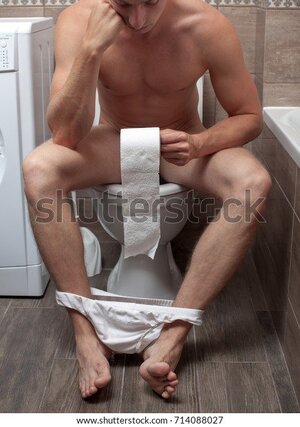 man-sitting-on-toilet-bowl-600w-714088027.jpg