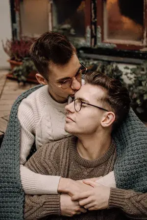 gay-couple-cuddling-with-blanket-u4vs24ns77ydc42o.webp