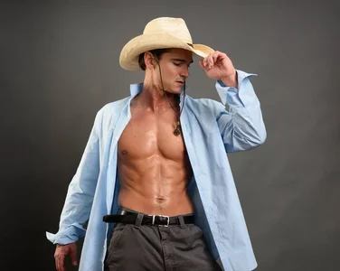 depositphotos_312624696-stock-photo-sexy-cowboy-strips-his-clothing.webp