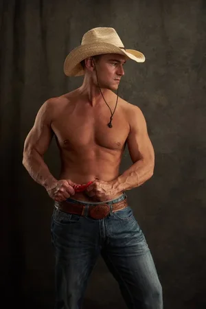 depositphotos_198860576-stock-photo-sexy-cowboy-shows-his-muscles.webp
