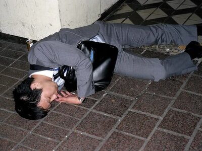 Striking photos of businessmen sleeping on dirty streets illustrate Japan's tireless work cul...jpeg