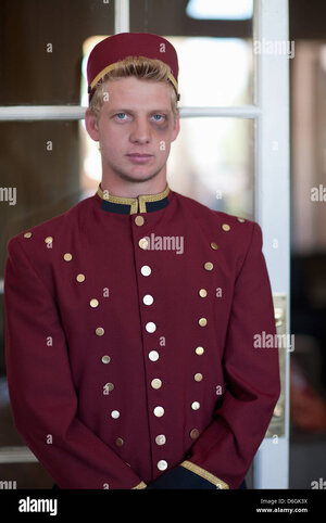 bellhop-with-black-eye-in-hotel-lobby-D6GK3X.jpg