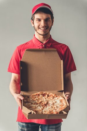 handsome-delivery-worker-red-uniform-is-holding-pizza_85574-7659.jpg