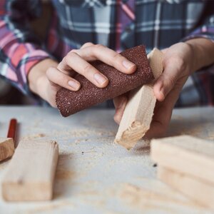 woman-using-sandpaper-Aliaksandr-Barysenka-GettyImages-1284357308.jpg