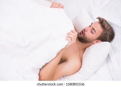 man-looking-under-blanket-morning-260nw-1580801536.webp