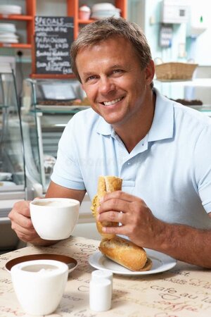 male-customer-enjoying-sandwich-coffee-cafe-16053717.jpg
