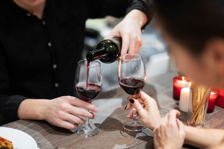 young-couple-celebrating-valentine-s-day-while-having-lunch-wine-together_23-2149216151.jpg