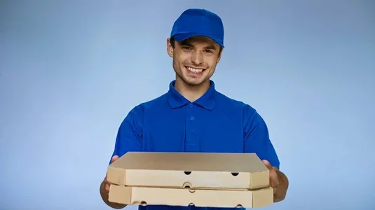 stock-photo-happy-delivery-man-holding-pizza-boxes-while-smiling-camera-isolated.webp