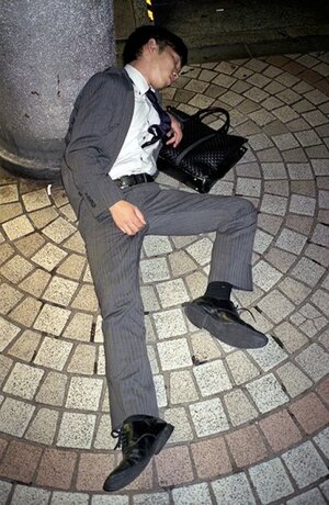 Photographer documents drunk businessmen snoozing on the streets of Tokyo.jpeg