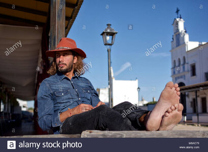 pensive-cowboy-waits-lazily-in-a-sleepy-spanish-village-M6AC79.jpg