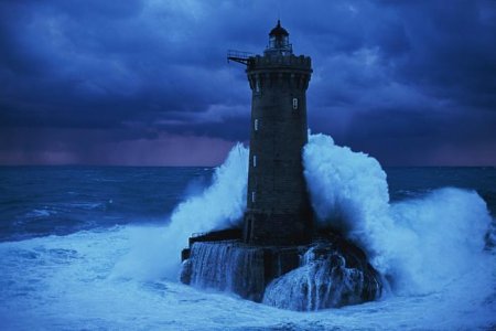a-lighthouse-braces-itself-against-the-ocean-in-a-picture.jpg