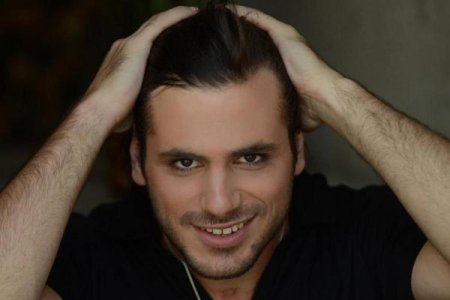 Stjepan brushing hair back.jpg