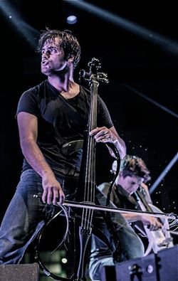 stjepan bluejeans on knees on stage playing.jpg