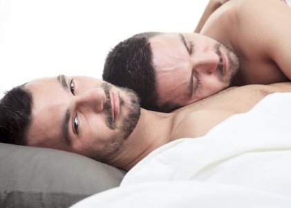 couple-in-bed-intimacy-love-snuggle-gay-men-cuddle-sex-lgbt-smile-thinking1.jpg