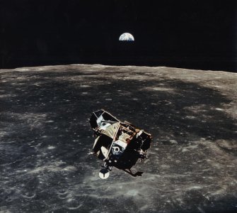 50-Years-Apollo-11-Lunar Module containing Buzz Aldrin and Neil Armstrong with Earth in the back.jpg