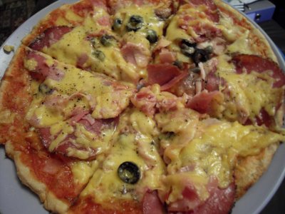 thin base pizza with meat, olives, anchovies and capers.jpg