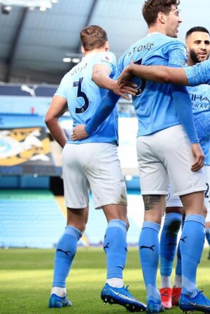 MANCHESTER-ENGLAND-FEBRUARY-27-Ruben-Dias-of-Manchester-City-celebrates-with-teammates-after-sco.jpg