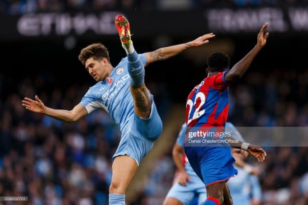 MANCHESTER-ENGLAND-OCTOBER-30-John-Stones-of-Manchester-City-and-Odsonne-Edouard-of-Crystal-Pala.jpg